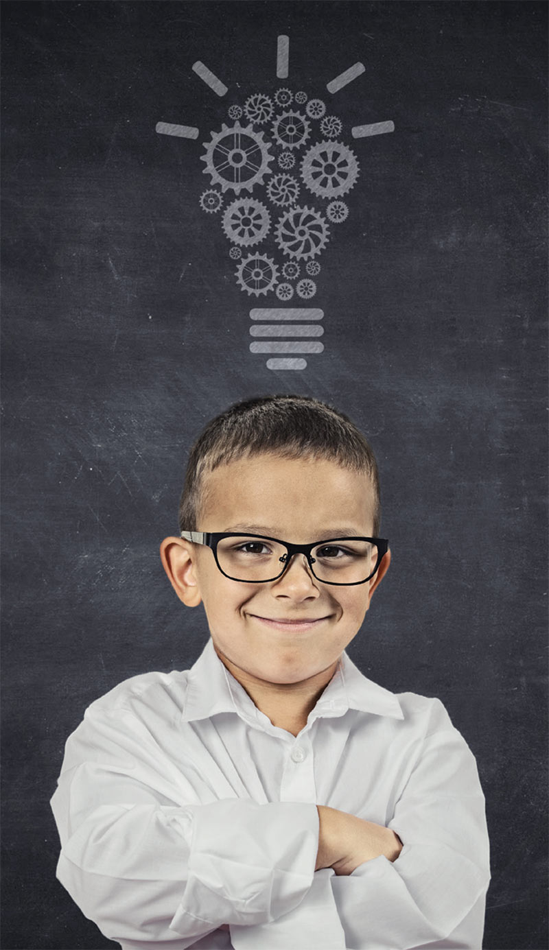 Boy Smiling under the Birth to 22 logo on a chalk board